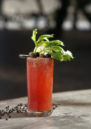 juice with leaves and olives on top