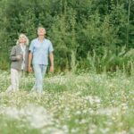 elderly couple walking on a flower field